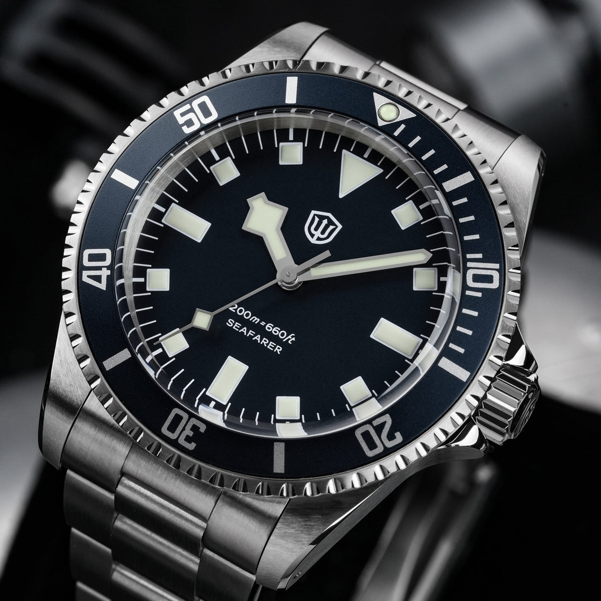 Watchdives WD5514Q 40mm quartz dive watch, blue dial with snowflake hands and white indices, angled wrist shot, 316L stainless steel bracelet.