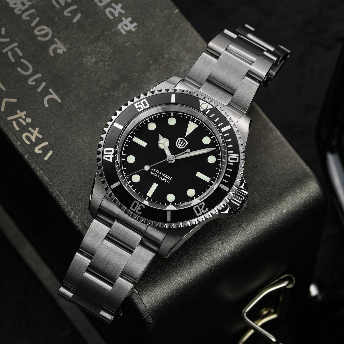 Watchdives WD5514Q 40mm quartz dive watch, matte black dial with sword hands, watch displayed on textured surface, 316L stainless steel bracelet.