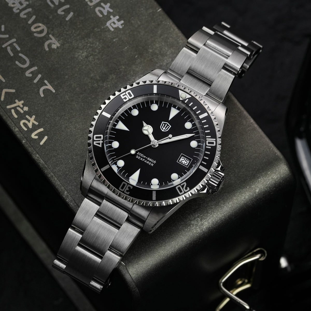 Watchdives WD5514Q 40mm quartz dive watch, matte black dial with Mercedes-style hands and date, watch displayed on textured surface, 316L stainless steel bracelet.
