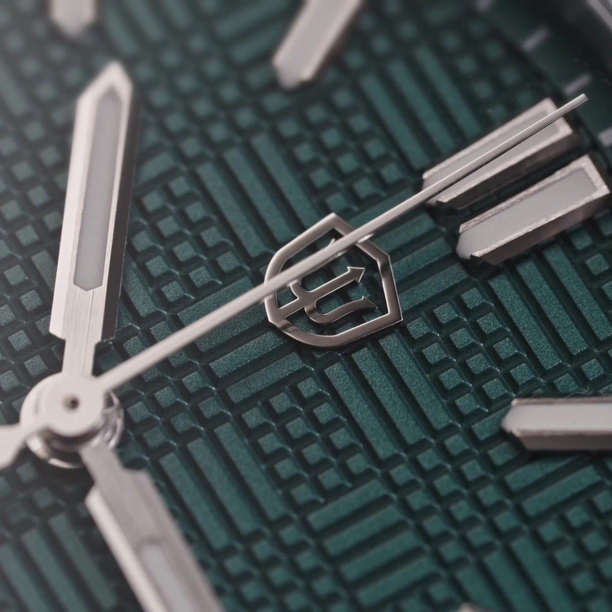 Watchdives WD2007A teal blue dial macro showing geometric texture and applied logo